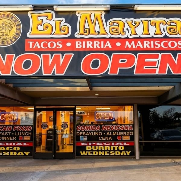 El Mayita restaurant exterior with a "NOW OPEN" banner, advertising tacos, birria, and mariscos.
